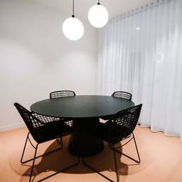 meeting room with black table and chairs with neutral floor colour