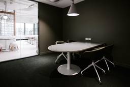 meeting room design dark walls and carpet next to white room