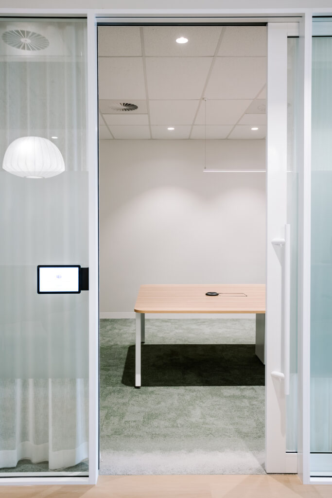 Glass-walled small meeting room with timber table in the Children’s Hospital Foundation office